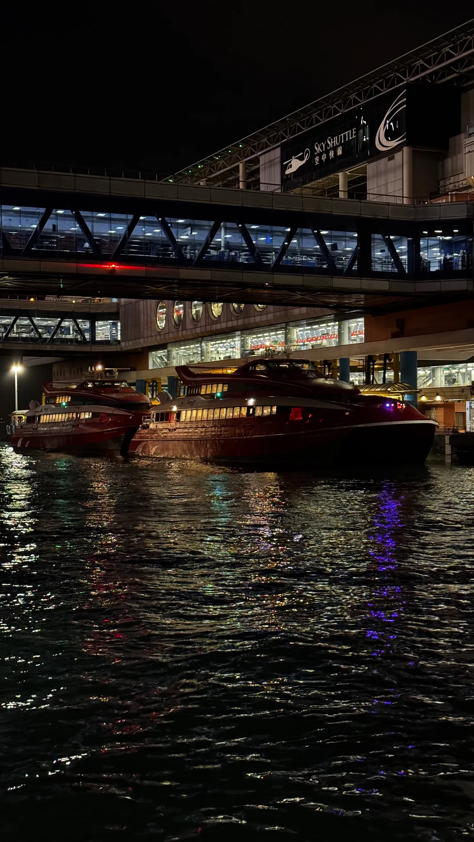 Ferries Sky Shuttle rouges à quai, reflets sur l'eau
